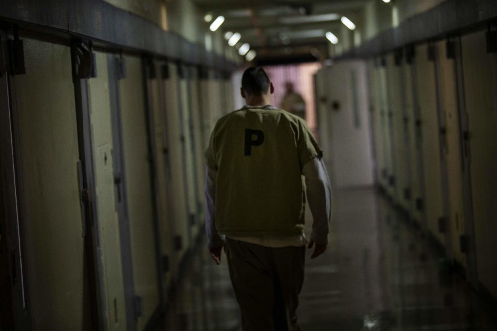 An inmate walks down one of the hallways of Worcester County jail. (Jesse Costa/WBUR)