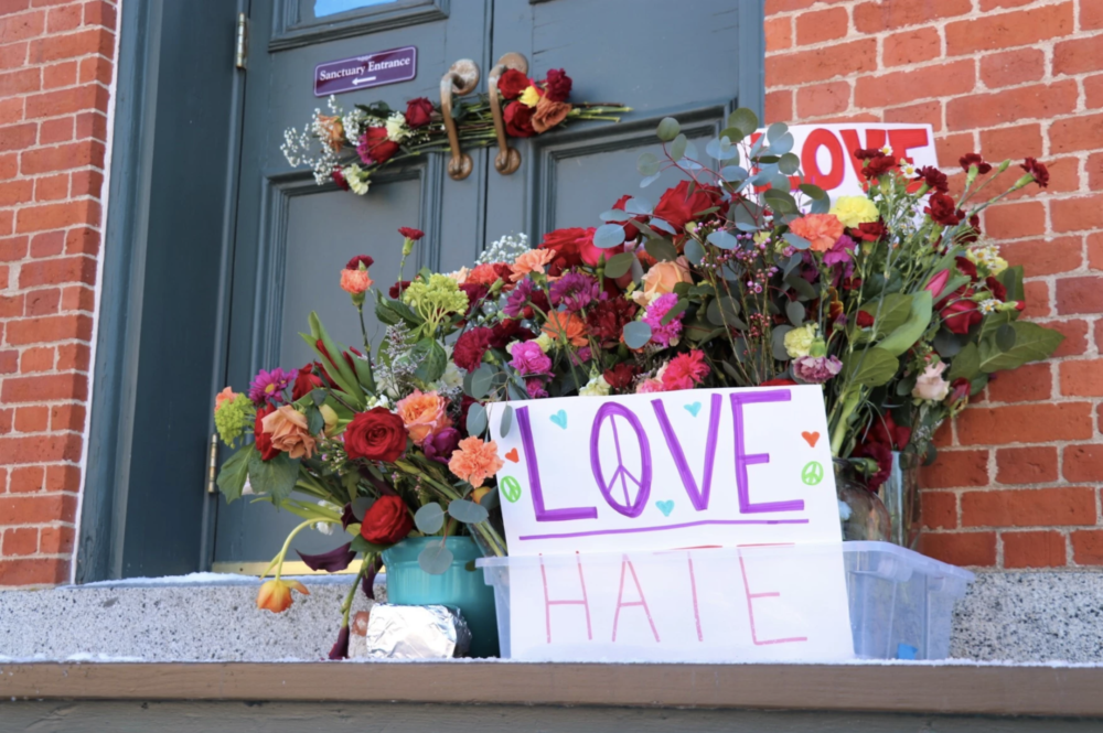Following a spate of vandalism, Portsmouth organized 'Love Blooms Here,' an event where flowers were left with impacted businesses and Temple Israel. (Dan Tuohy/NHPR)